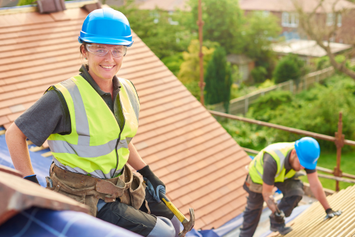 Two people working on a roof